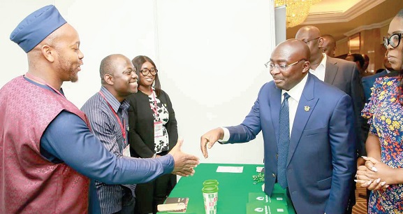 Dr Mahamudu Bawumia (right) interacting with Darryl Abraham Mawutor (left), Growth Director in charge of Africa for Taptap Send Africa, and other members of the team