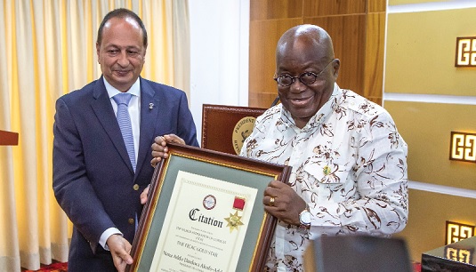 Nikolaos Margaropolous, President, World Federation of Consuls, presenting a citation to President Nana Addo Dankwa Akufo-Addo
