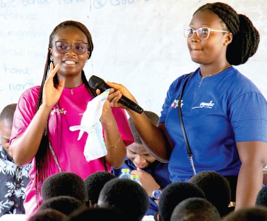 Elizabeth Konadu-Boakye (left), a menstrual health and hygiene advocate, demonstrating how to use a pad 