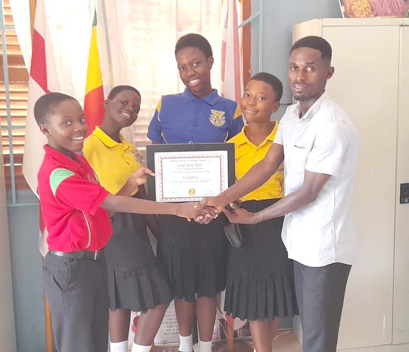 • The debate champions proudly show off their certificate of participation.
