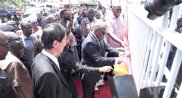 Nana Addo Dankwa Akufo-Addo (inset) cutting the tape to commission the GRIDCo 161kV Accra Central Bulk Supply Point. Assisting him is Dr Zanetor Agyeman-Rawlings (2nd from left, partly covered) and Henry Quartey (right), Greater Accra Regional Minister. Looking on is Mochizuki Hisanobu, Japanese Ambassador to Ghana. Picture: EDNA SALVO-KOTEY