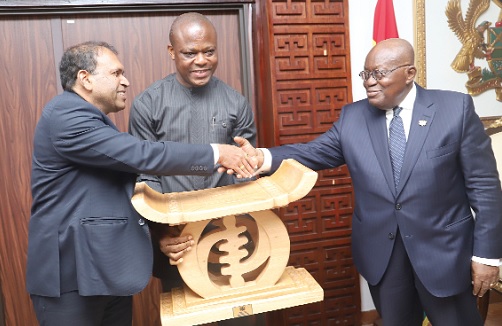 President Akufo-Addo presenting a gift to Sugandh Rajaram (left), outgoing Indian High Commissioner to Ghana. With them is Samuel Kumah, Director of Protocol