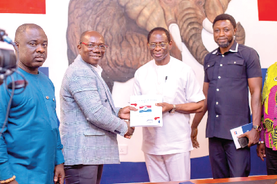 • Dr Kofi Konadu Apraku (2nd from right) presenting his nomination papers to Evans Nimako, NPP Director of Research and Elections