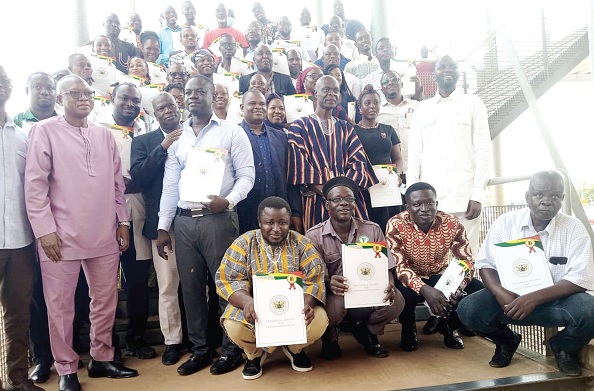 Shani Alhassan Shaibu (arrowed), Northern Regional Minister, with some of the staff displaying their awards