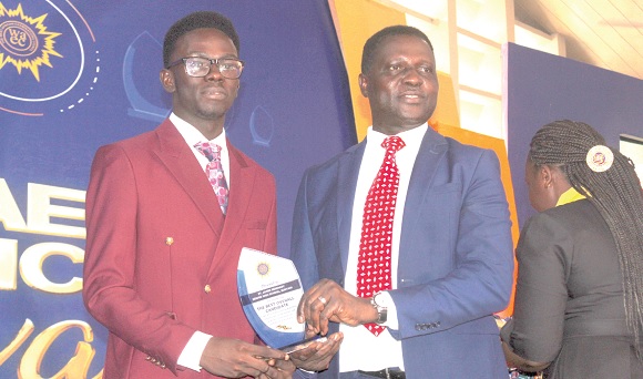 Alex Opoku Manu (left) receiving the award for the first position from Dr Yaw Osei Adutwum, Minister of Education. Picture: ESTHER ADJORKOR ADJEI