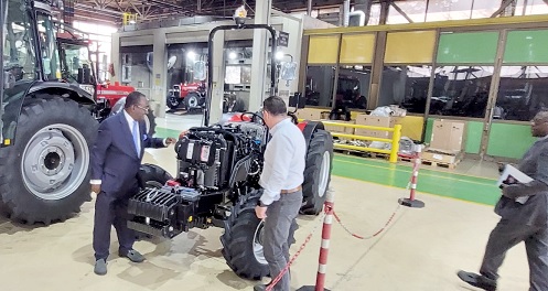 Dr Owusu Afriyie Akoto (right) observing the make of one of the tractors