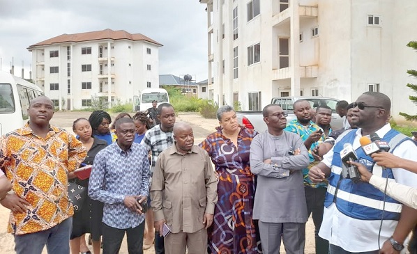 Mr Appiah (right), the MD of the SHC, briefing the Works and Housing Committee members at the Little London apartments in Adentan