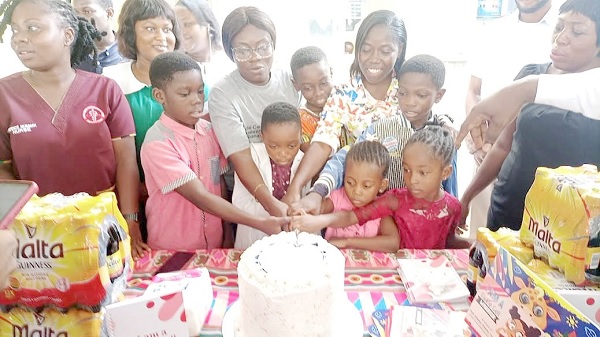 Some children who are Sickle Cell Disease (SCD) patients being assisted by healthcare givers to cut the cake presented to them to mark World Sickle Cell Day 