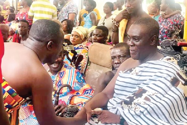 Oseadeeyo Agyemang Badu II (right), President of the Bono Regional House of Chiefs, exchanging pleasantries with Ansu Kumi (back to camera), the Sunyani Municipal Chief Executive