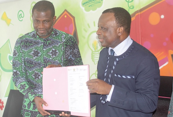Mark Okraku-Mantey (left), Deputy Minister of Tourism, Arts and Culture, and Jules-Armand Aniambossou (right), French Ambassador to Ghana, displaying the document after signing the memorandum of understanding with Expertise France to support the expansion of music in Ghana. Picture: ESTHER ADJORKOR ADJEI