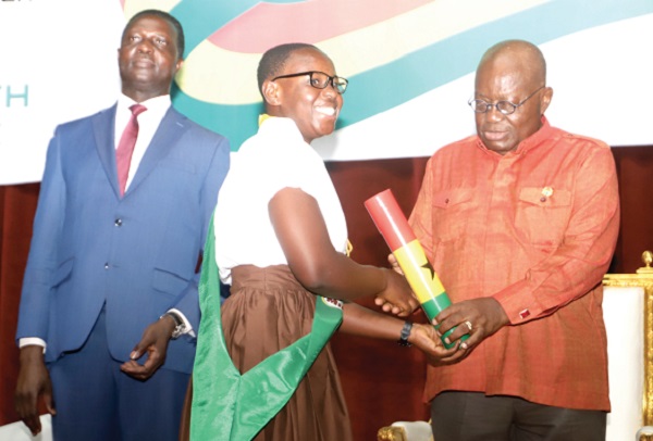  President Akufo-Addo (right) presenting the independence Day Award to Sussana Dansoa (middle), a visually impaired student of the Okuapemman Senior High School, at the ceremony in Accra. Looking on is Dr Yaw Osei Adutwum (left), Minister of Education. Picture: GABRIEL AHIABOR