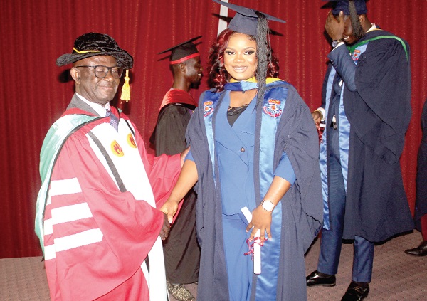 Kwame Adjei-Seffah (left), Dean of Business School, Zenith University College, congratulating Sylvia Ifeoma Anoruo, who obtained first class in Bachelor of Business Administration. Picture: ESTHER ADJORKOR ADJEI