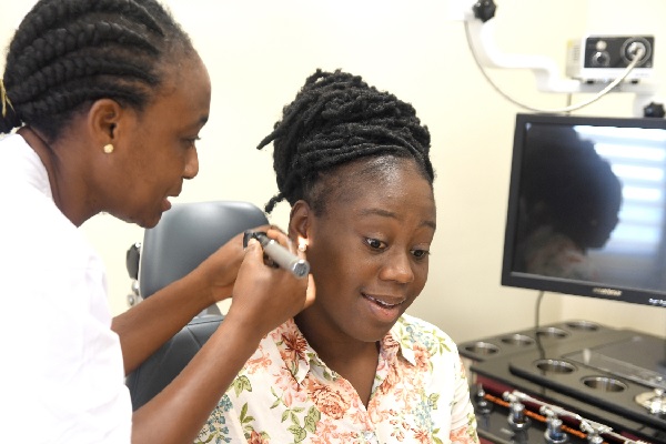 • Josephine Dogbevi, Deputy Director of Nursing Services of the University of Ghana Medical Centre, examining a patient during the celebration of World Hearing Day at the centre. Picture: EMMANUEL QUAYE