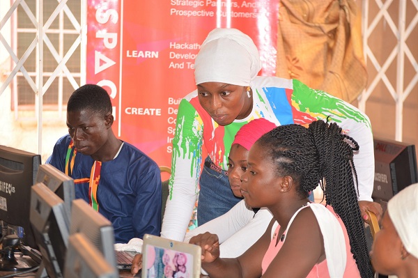Ms Abdullah assisting participants at a coding event organised by Divaloper Divaloper Training