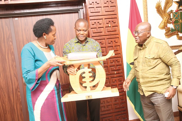  President Akufo-Addo presenting a gift to Dr Aissa Kirabo Kacyira (left), the outgoing Rwandan High Commissioner to Ghana. With them is Samuel Kumah, Director of Protocol. Pictures:  SAMUEL TEI ADANO