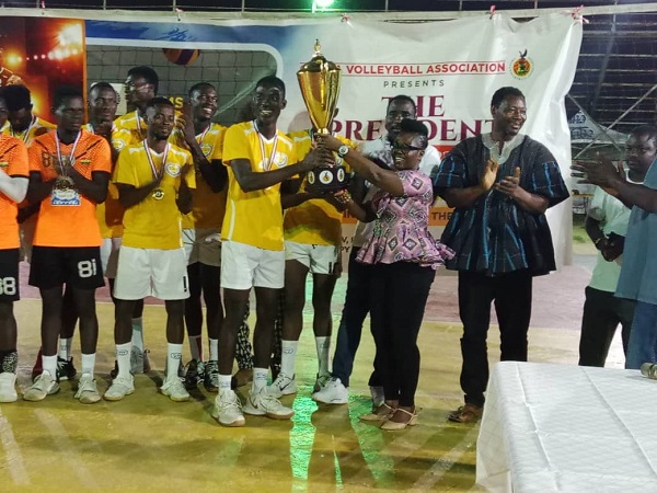 Madam Vivien Nyoni, the PRO of the Ghana Volleyball Association (right) with Mr George Tettey presenting the trophy to El-Wak Wings Captain Eliot Javi