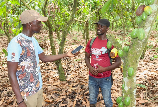 Our reporter engaging one of the beneficiary farmers
