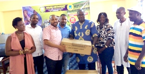 • Dr Clement Kadogbe, President of AMESTOSA, presenting a box of light bulbs to John Apo Selby, Headmaster of the school