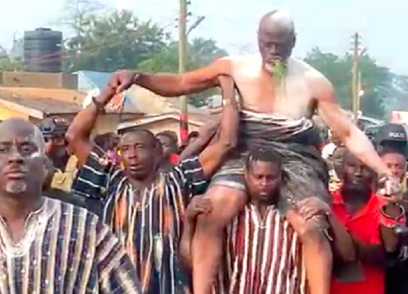 •Odehyie Kojo Boa Amoako-Atta Ayim (seated left on the floor) going through rituals prior to his installation. RIGHT: The newly installed chief being paraded through the streets of Kyemanuasi Akakom after going through the installation rituals 