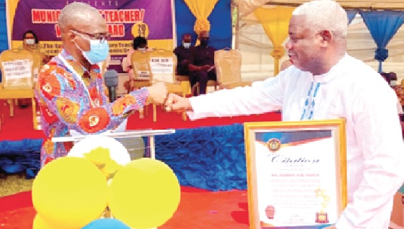• Flashback: Victor Noye Tawiah (left), the Ledzokuku Municipal Director of Education, exchanging pleasantries with Benjamin Ayiku, MP for the area, after presenting a citation to him for his contribution to education in the area