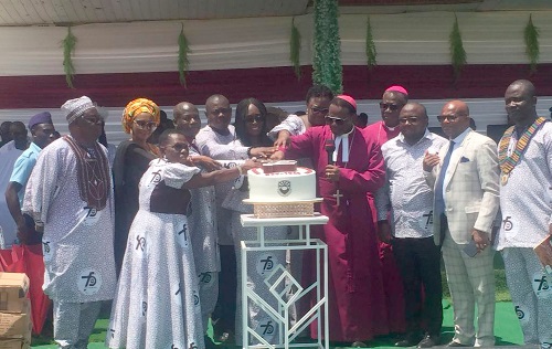 Gifty Twum Ampofo (arrowed), a Deputy Minister of Education, with the clergy and other dignitaries cutting the anniversary cake