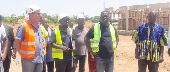 • Ignatius Baffuor-Awuah (2nd from right) being shown the extent of work by Gabriel Antwi (2nd from left), the Site Engineer