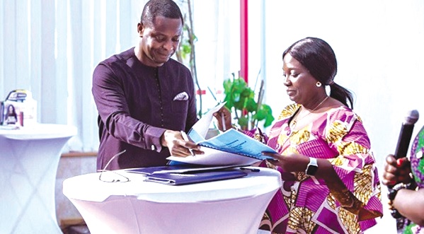 • Mrs Linda Asante Adjei (right), Vice President of GJA, signing the MOU with Dr Collins Yeboah — Afari the Director General of GI-KACE