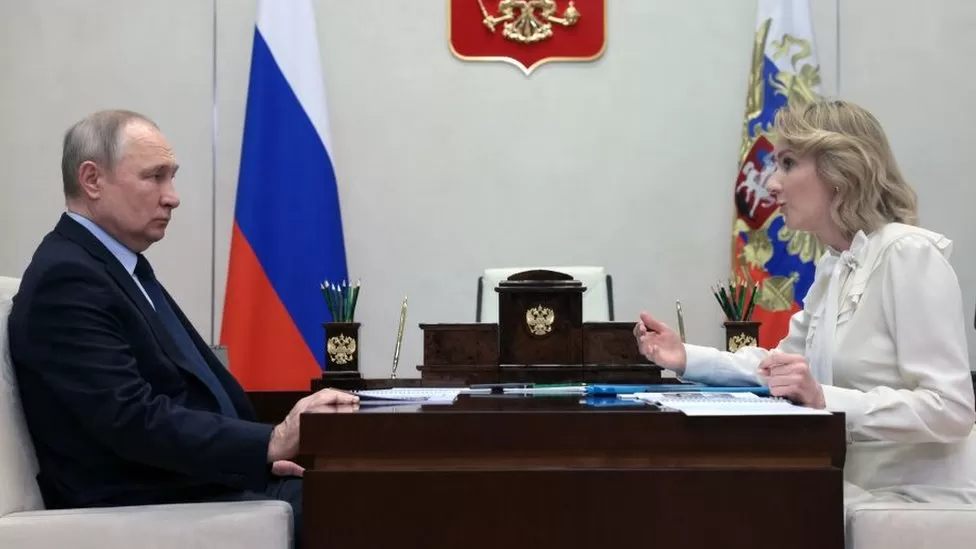  Image caption, Vladimir Putin and Maria Lvova-Belova, Russia's commissioner for children's rights, during a meeting last month