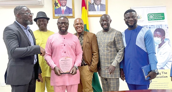 • Dr Fred Kyei Asamoah (3rd from left with the award shield), Director-General of CTVET, with some staff of the commission after receiving the award