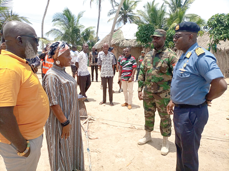  Naval Captain Ben Baba Abdul (right), acting Flag Officer Commanding, Riverine Command of the Ghana Navy, briefing Comfort Doyoe Cudjoe-Ghansah (2nd from left), the MP for Ada, during the tour