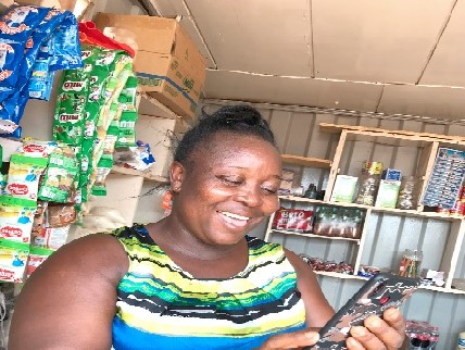 Mrs Elizabeth Amefo, a provision shop owner takes orders from her customers on WhatsApp