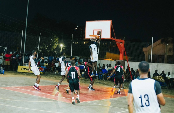 Spintex Knights (white jersey) finish a passing move with a dunk