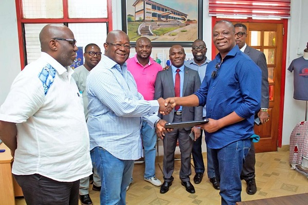 Mr. Baakoe (right) present one of the laptops to Ebusuapanyin Paul Forjoe.