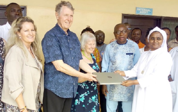 • Douglas Loveday (2nd from left) presenting a laptop to Rev. Sis. Reena V. John, Administrator of the Berekum Holy Family Hospital. With them are Ruth Loveday (middle), his wife, and Juliana Loveday (left), his daughter, who was born at the hospital 50 years ago