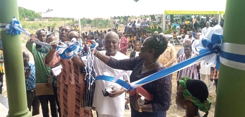 • Justice Victor D. Ofoe (2nd from right) being assisted  by Paulina A. Kwakyewaa (right), the Ada District Magistrate, and Sarah Dugbakie Pobee (3rd from right) to inaugurate the new library. INSET: Front view of the library. Picture: Benjamin Xornam Glover