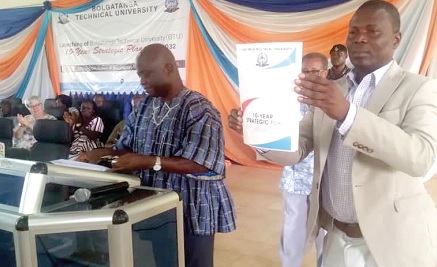 • Professor Samuel Erasmus Alnaa (right), Vice-Chancellor of BTU, displaying the plan after it was launched by Stephen Yakubu (left), Upper East Regional Minister