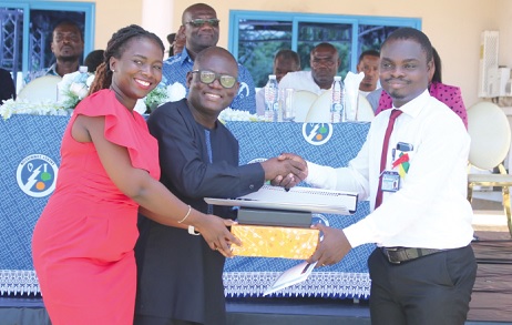 • Kojo Ayensu (2nd from left) being assisted by an official of Nexans Kabelmetal to present the overall best student award to Nobel Akortia. Picture: DELLA RUSSEL OCLOO