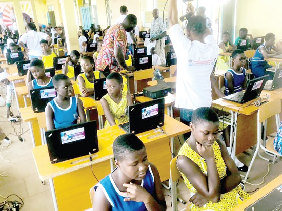 • Female students in a classroom busily learning ICT to mark this year's International Day of Girls in ICT