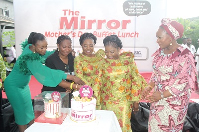 Doreen Hammond (2nd from left), Editor, The Mirror,  being assisted by the Tagoe Sisters and Diana Asamoah (left) to cut the cake. Looking on is Samira Bawumia (right), wife of the Vice-President  
