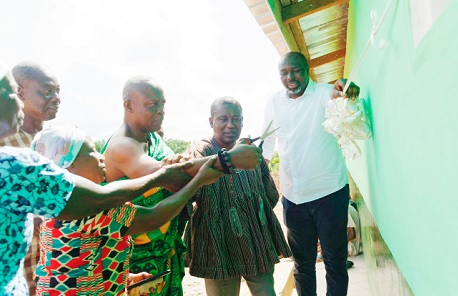Nana Kwesi Agyeman IX (2nd from right), the Paramount Chief of Lower Dixcove Traditional Area, being assisted by Perry Acheampong (right), Corporate Affairs Manager of GREL, and other members of the community to open the facility