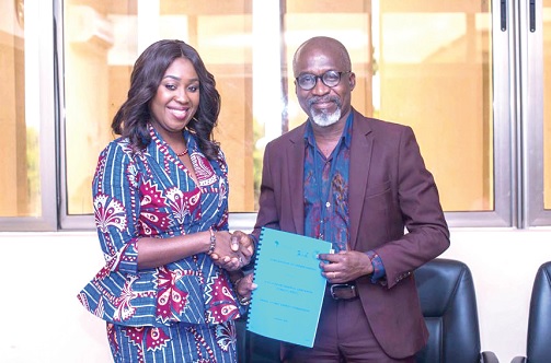 Dr Abena Asomaning Antwi (left), MD, AfESC, exchanging the signed documents with Professor Samuel Boakye Dampare (right), Director-General, GAEC