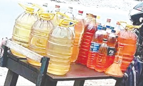 Sale of fuel in plastic containers on table tops