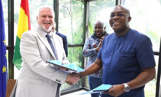 Ward Caldwell (left), CEO of R.A & Sons Manufacturing Limited, and Dr James Orleans- Lindsay, CEO of JL Properties, exchanging documents after signing the MOU while Michael Okyere Baafi (right), Deputy Minister of Trade and Industry, looks on. Picture: EBOW HANSON