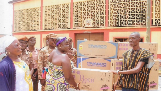 Napaga Kaziya Asana Salifu presenting the air conditioners to the  Bopam Augustine (right), Assistant Director of Yendi Prisons