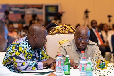 President Akufo-Addo interacting with the Minister of Lands and Natural Resources, Samuel Abu Jinapor, at the stakeholder dialogue