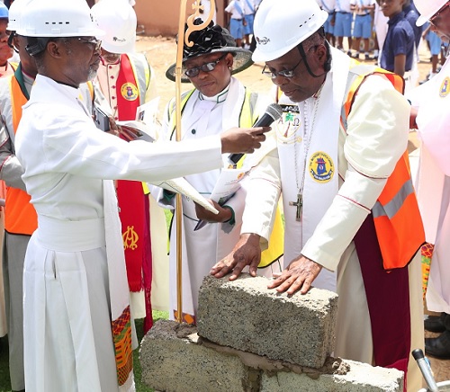 Rt Rev. Emmanuel Borlabi Bortey (right), the Bishop of the Accra Diocese of the Methodist Church Ghana, laying the foundation stone for a multi-purpose building project for the Good Shepherd Methodist Church in the Kaneshie North Circuit