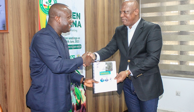 Ato Afful (right), MD, Graphic Communications Group Limited, presenting the report to Samuel Jinapor, Minister of Lands and Natural Resources. Picture: ERNEST KODZI