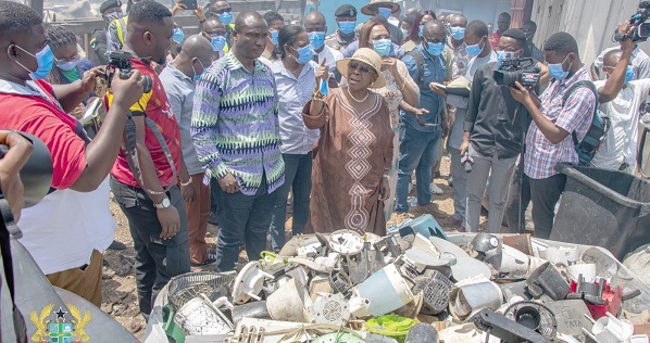 Cecilia Abena Dapaah (arrowed), Minister of Sanitation and Water Resources,  commenting on some e-waste at Old Fadama in Accra