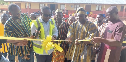 Sulley Sambian (2nd from left), CEO, NDA, inaugurating the three-unit classroom block (inset) at Zaghe. With him is Bayiriyelle Dassah (3rd from left), Chief of Zaghe, and other elders of the town
