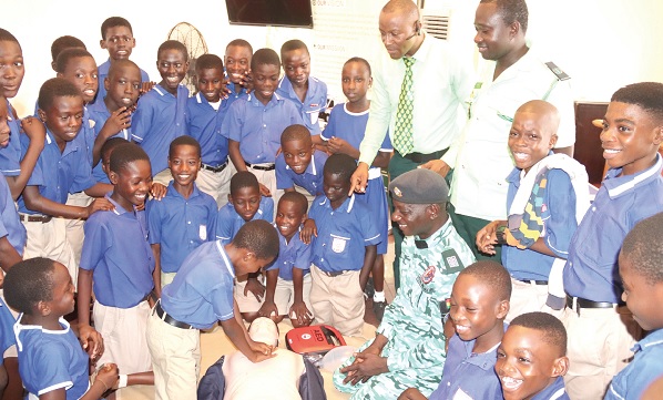 David Nii Addy, a Class 5 pupil of Bishop’s Mixed Primary  School, practising a CPR procedure during the training. Looking on is Alhassan Mohammed Mashud (standing right), Head of Special Operations, National Ambulance Serivce. Picture: ELVIS NII NOI DOWUONA